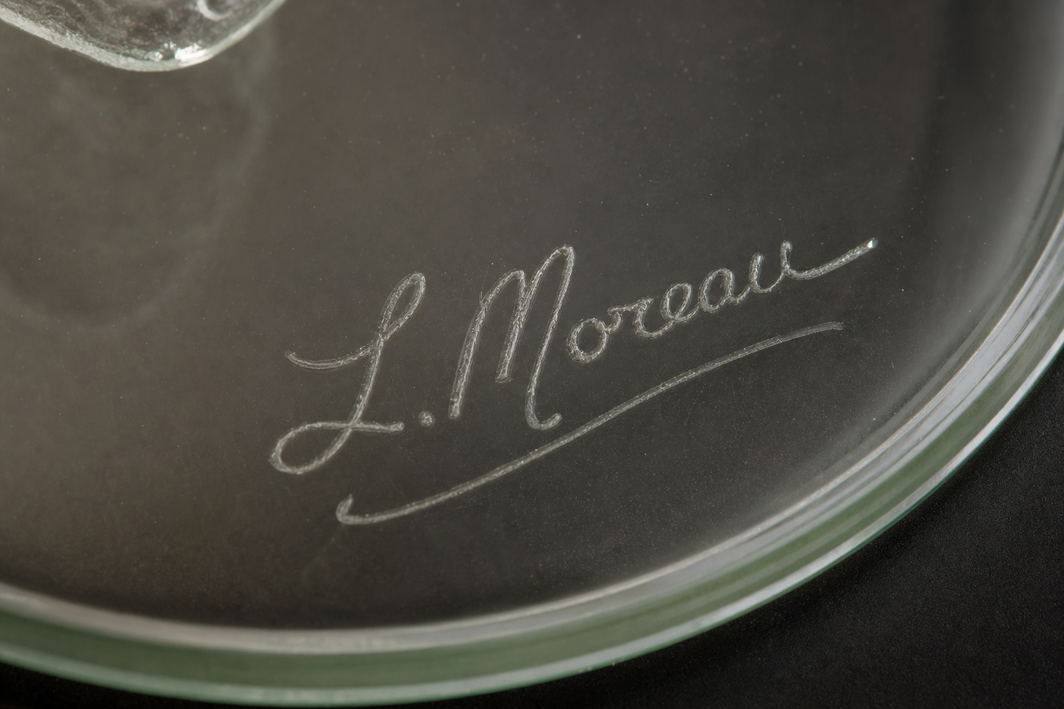 Peggy Karr scripted signature on the back of a fused glass plate